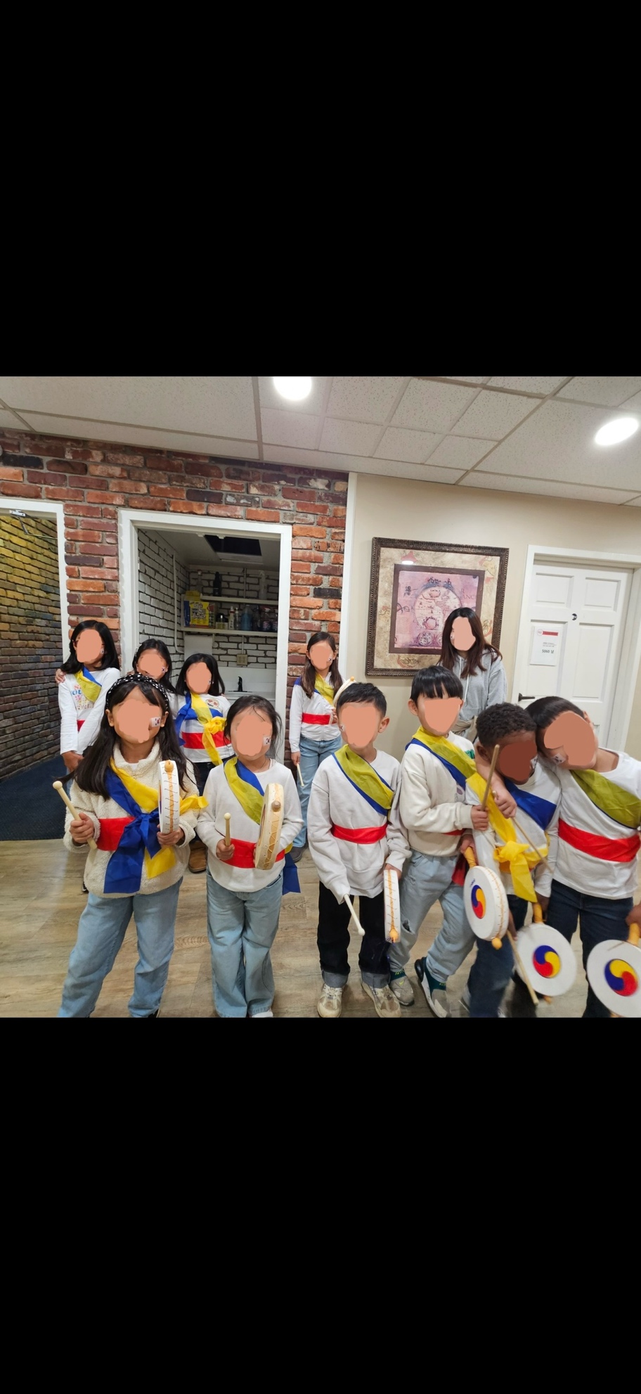 Korean School students holding small traditional Korean drums