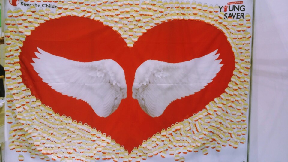 A heart-shaped photo wall bordered by handwritten notes