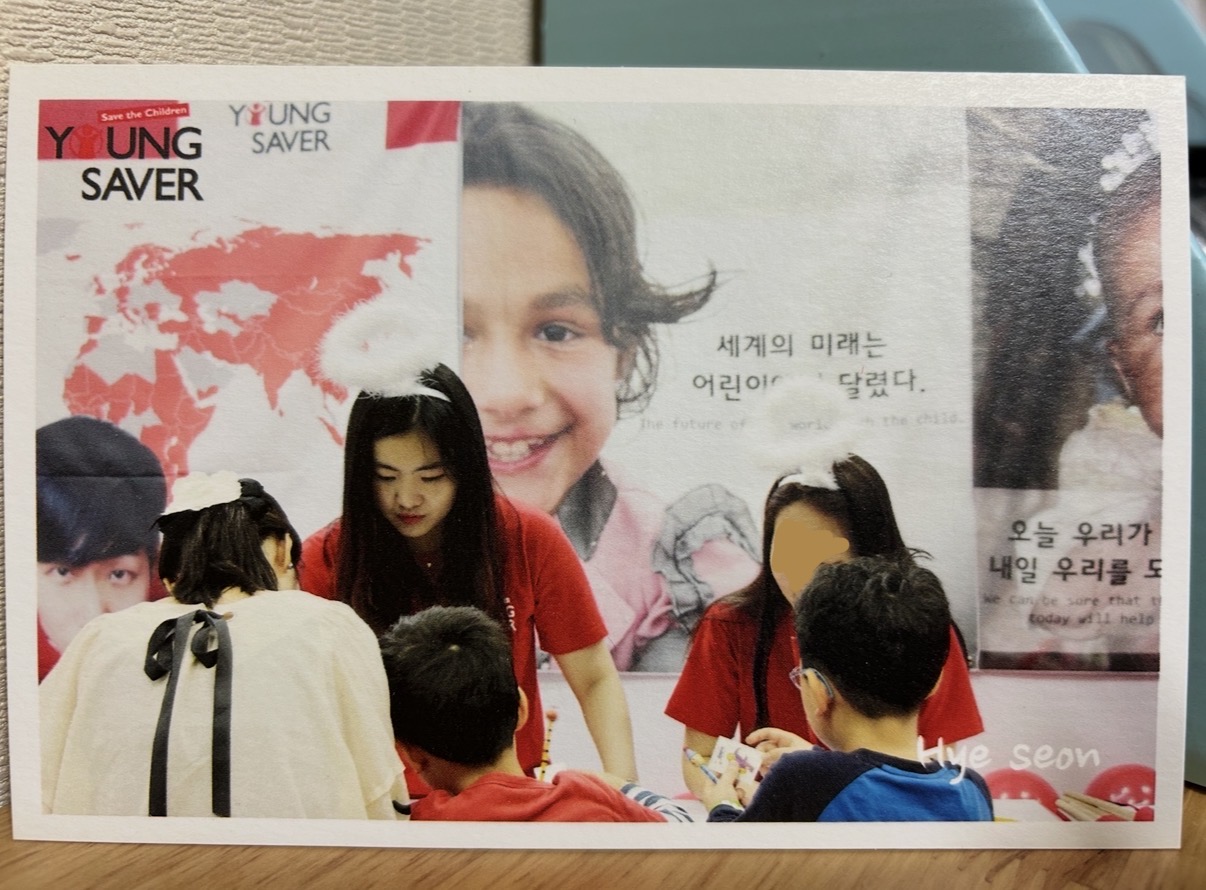 Hyeseon Noh making a display wall with students at a Young Saver event